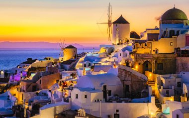 White churches an blue domes by the ocean of Oia Santorini Greece, a traditional Greek village in Santorini.
