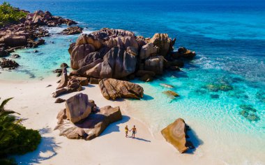 Anse Cocos La Digue Seyşeller, Seyşeller 'de lüks bir tatil sırasında tropik bir plajda birkaç kadın ve erkek. Tropik sahil Anse Cocos La Digue Seyşeller. 