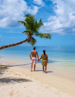 Mahe Seyşeller, Mahe Seyşeller 'de palmiye ağaçları ve mavi okyanusları olan tropikal bir plaj. Anse Royale plajı, tatildeki çift erkek ve kadın Seyşeller. 