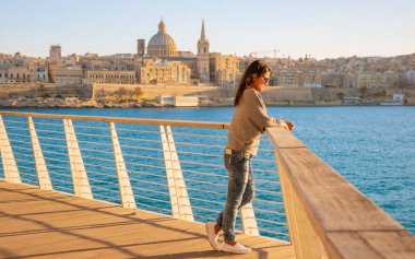 Valletta Malta 'da günbatımını izleyen Asyalı kadınlar Skyline, renkli balkon Malta Valletta, gün batımında Valletta Malta eski kasabasının panoramik manzarası