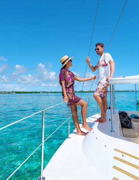 Man and Woman on a boat trip at a sailing boat in Mauritius, a couple on a honeymoon vacation in Mauritius