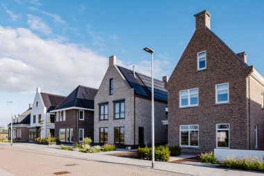 Modern aile evleri olan Hollanda Suburban bölgesi, Hollanda 'da yeni inşa edilmiş modern aile evleri, Hollanda' da Hollandalı aile evi, modern evlerle yeni inşa edilmiş sokak