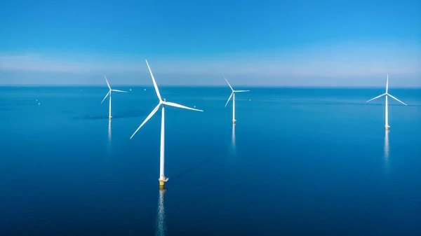 stock image offshore windmill park with clouds and a blue sky, windmill park in the ocean aerial view of wind turbine Flevoland Netherlands Ijsselmeer. Green energy 