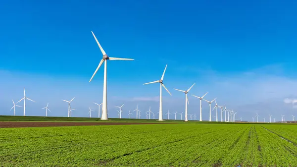 stock image windmill park and a blue sky, windmill park in the ocean aerial view with wind turbine Flevoland Netherlands Ijsselmeer