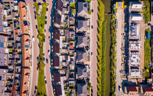 Dutch Suburban area with modern family houses, newly build modern family homes in the Netherlands, dutch family house in the Netherlands, drone view from above at a street with modern house