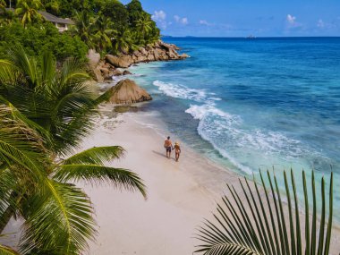 Anse Patates beach, La Digue Island, Seyshelles, Drone aerial view of La Digue Seychelles bird eye view.of tropical Island. mature couple men and women on vacation in Seychelles