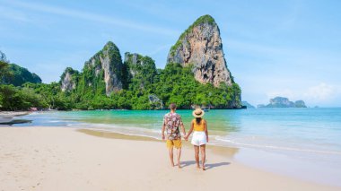 Railay Beach Krabi Thailand, the tropical beach of Railay Krabi, a couple of men and women on the beach, Panoramic view of idyllic Railay Beach in Thailand 