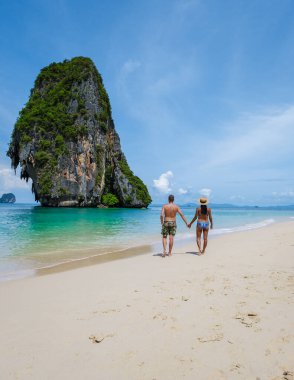 Railay Beach Krabi Thailand, the tropical beach of Railay Krabi, a couple of men and women on the beach, Panoramic view of idyllic Railay Beach in Thailand 