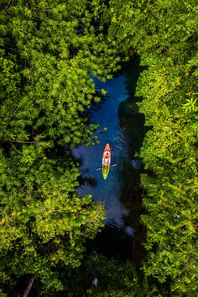 couple in a kayak in the jungle of Krabi Thailand, men and women in a kayak in a tropical jungle in Krabi mangrove forest.