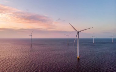 Rüzgâr türbini Flevoland Hollanda Ijsselmeer ile okyanus manzaralı Windmill Parkı 'nda gün batımı. Hollanda 'da Yeşil Enerji Üretimi