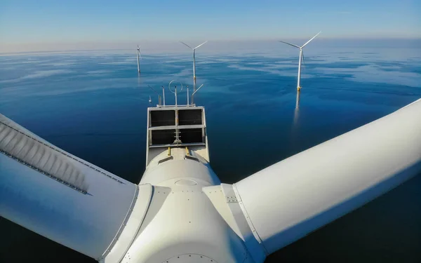 Wind turbine in the ocean, Wind Farm Amidst a Sunny blue Landscape, Where Elegant Turbines Embrace the Promise of Renewable Energy