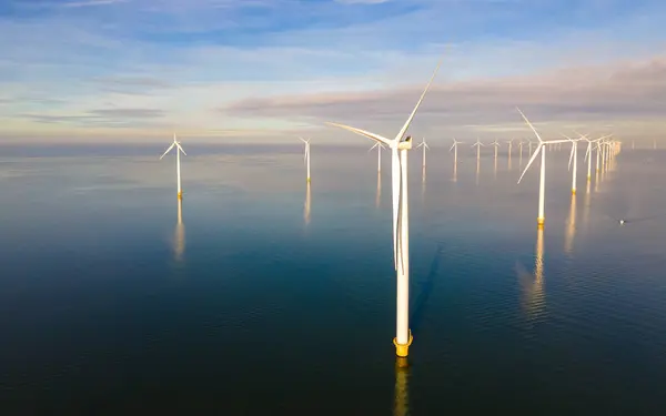 Ocean Wind Farm. Windmill farm in the ocean. Offshore wind turbines in the sea. Wind turbine from aerial view. in the Netherlands