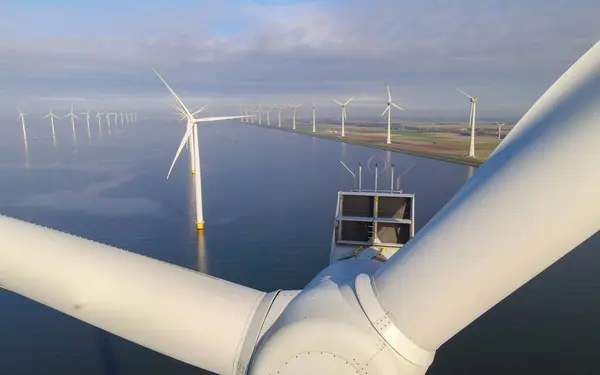close up the ocean Wind Farm turbines. Windmill farm in the ocean. Offshore wind turbines in the sea. Wind turbine from an aerial view,