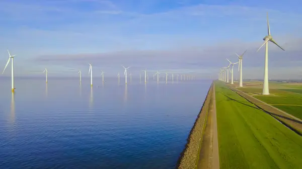 ocean Wind Farm. Windmill farm in the ocean. Offshore wind turbines in the sea. Wind turbine from an aerial view, in the Netherlands during summer