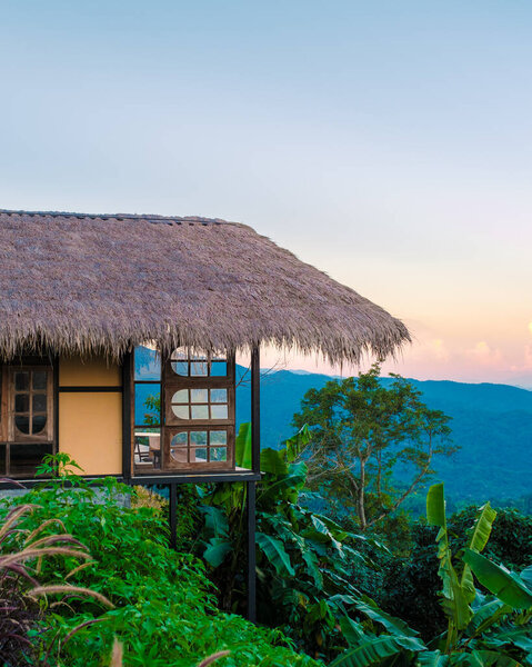 Homestay in the Doi Chang mountains of Chiang Rai Northern Thailand, bamboo wooden hut in the mountains, cottage cabin at sunset