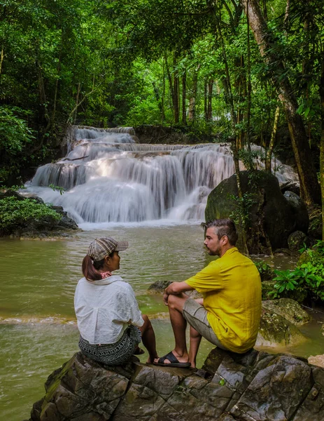 Erawan Waterfall Thailand Kachanaburi, a beautiful deep forest waterfall in Thailand. Erawan Waterfall in National Park. a couple of men and women on a trip visiting nature with forest and waterfalls