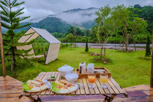 breakfast in the mountains of Northern Thailand. American and Thai breakfast with rice soup, sausages and bread