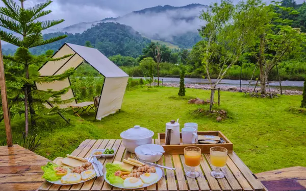 breakfast in the mountains of Northern Thailand. American and Thai breakfast with rice soup,sausages and bread