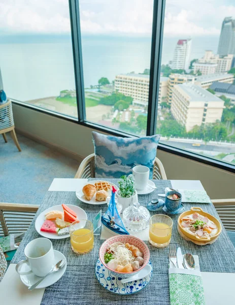 Thai breakfast in a luxury hotel in Thailand, noodle soup, and Thai egg pan, table with Asian breakfast