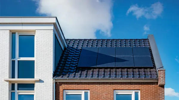 Newly built houses with solar panels attached on the roof,Solar photovoltaic panels on a house roof in the Netherlands