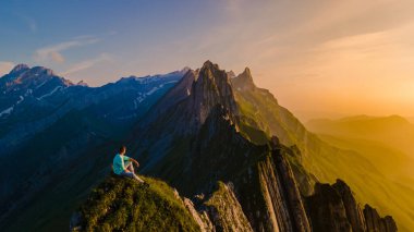 Schaeffler Dağı Sırtı İsviçre Alpstein Appenzell İsviçre, Berggasthaus Schafler İsviçre 'nin görkemli Schaeffler zirvesinin bir dağ sırtı. Gün batımında dağlarda bir adam