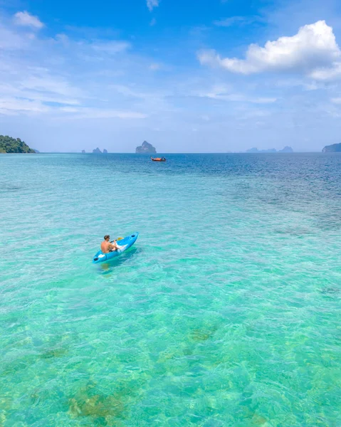 在Koh Kradan的蓝色船屋海的一艘皮划艇上的年轻人 在阳光灿烂的一天 在泰国Koh Kradan Trang Kradan是一个热带岛屿 海洋中有珊瑚礁 — 图库照片
