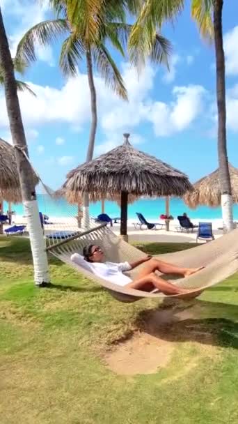Woman Relaxes Hammock Tropical Beach Surrounded Lush Palm Trees Sound — Stock Video