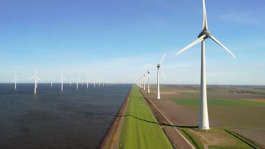 Okyanustaki yel değirmeni parkı, elektrik üreten yel değirmeni türbinlerinin insansız hava görüntüsü Hollanda 'da denizde izole edilmiş yel değirmenleri. Karadaki ve denizdeki hendekteki yel değirmenleri