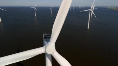 Okyanustaki yel değirmeni parkı, elektrik üreten yel değirmeni türbinlerinin insansız hava görüntüsü Hollanda 'da denizde izole edilmiş yel değirmenleri. sıfır emisyon karbon nötr 2030