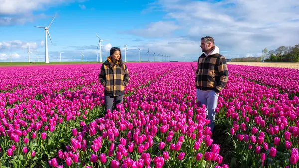 Two People Stand Amidst Vibrant Sea Wildflowers Dutch Field Embraced Stock Picture