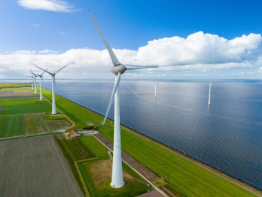 Serene wind farm with sleek turbines dancing gracefully near the ocean in the Netherlands on a clear Spring day. clipart