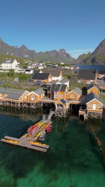 Norveç 'in Lofoten Adaları, Norveç' in Sakrisoy, Norveç, İskandinavya 'nın tarihi köyünde geleneksel sarı balıkçı Rorbuer kulübeleriyle Lofoten Adaları manzarası