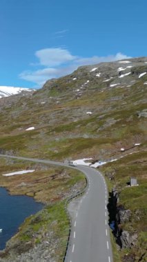 Norveç dağları boyunca, göz kamaştırıcı doğal bir zemin üzerine kurulmuş pitoresk bir viraj yolu. Langvatnet, Geiranger, Norveç