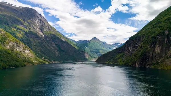 stock image A picturesque view of a calm fjord surrounded by lush green mountains in Norway. lovatnet lake Lodal valley Norway