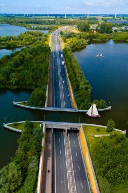 Aquaduct Veluwemeer 'in hava görüntüsü, Hollanda' da benzersiz bir köprü. Açık bir alanı olan bir kanalın altından geçen bir otoyol, botların otobanın üzerinden geçmesine olanak sağlıyor.