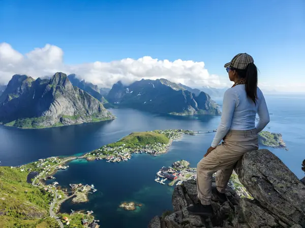 stock image A breathtaking vista captured from a rocky summit, showcasing the stunning Lofoten Islands surrounded by shimmering waters under a clear blue sky. Reinebringen Lofoten Norway 