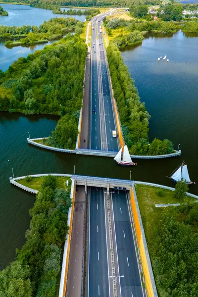 stock image An aerial view of the Aquaduct Veluwemeer in the Netherlands, showcasing a highway crossing a canal. The unique design allows boats to pass through above the road.