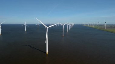 Hollanda 'nın çarpıcı yel değirmeni türbini manzarasını araştırın, sürdürülebilirlik için hayati önem taşıyan yenilikçi yeşil enerji çözümlerini vurgulayın ve küresel ısınmayı etkili bir şekilde ele alın