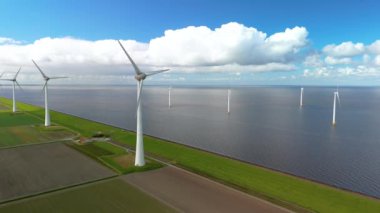 Hollanda 'daki yel değirmeni türbinlerinin pitoresk görünümünü keşfetmek ve takdir etmek, daha iyi bir gelecek için sürdürülebilir yeşil enerji çözümlerine önemli bir geçişi simgeliyor