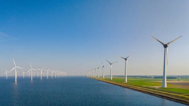 Hollanda, Flevoland 'da bulunan çarpıcı ve etkileyici rüzgar türbinlerini araştırın. Bu türbinler yeşil enerji çözümleri ve devam eden küresel sürdürülebilirlik çabalarında kaydadeğer gelişmeler sergiliyor.