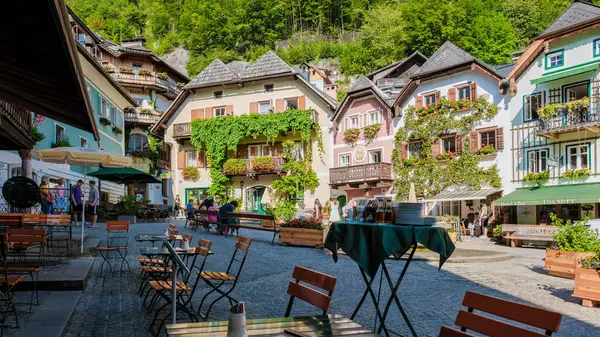 stock image Hallstatt Austria 25 August 2024, Discover Hallstatt, a charming village with colorful, lush buildings surrounding a cobbled square, perfect for relaxing in cafes and soaking up the summer atmosphere.