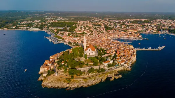 stock image As the sun sets over Rovinj, the vibrant colors reflect on the water, highlighting the charming towns historic architecture and stunning coastal landscape, inviting exploration and admiration.