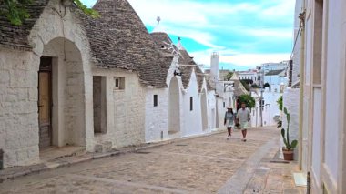 Alberobello 'nun büyüleyici ve büyüleyici sokaklarına dalın, güzel Puglia, İtalya' ya yerleşin ve çarpıcı mavi gökyüzüne karşı kurulmuş ikonik trulli evlere hayret edin.