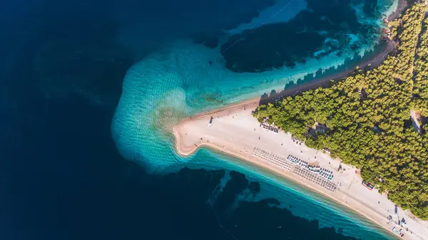 Zlatni Rat 'taki canlı plaj, benzersiz şekli ve altın kumlarıyla Brac Adası' nın sakin turkuaz sularıyla Hırvatistan 'ı ziyaret ediyor.