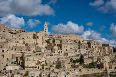 Nestled in the heart of Puglia, Matera boasts enchanting stone dwellings and a historical landscape under a brilliant blue sky, inviting visitors to wander through its rich cultural heritage. clipart