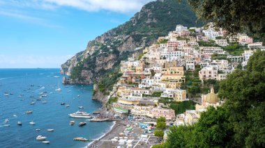 Vibrant houses cling to cliff edges in Positano, overlooking the tranquil waters of the Amalfi Coast. Positano on Italy Amalfi Coast clipart