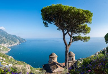 A striking panorama reveals the Amalfi Coast, showcasing coastal cliffs, vibrant Mediterranean flora, and historic structures. Ravello Italy clipart