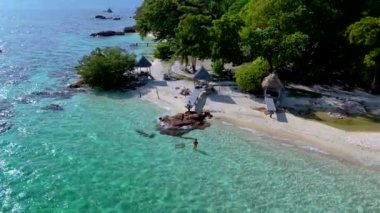 Kristal berrak suların yumuşak kumlu plajlarla buluştuğu Koh Munnork Adası 'nın güzelliğini keşfedin. Mükemmel bir rahatlama gününde yemyeşil ve sakin ortamın tadını çıkar. Kumsaldaki çift.