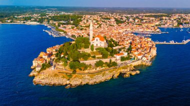 Rovinj Hırvatistan, yaz aylarında sıcak bir günbatımı parıltısı altında büyüleyici kıyı manzarası, canlı mimarisi ve tarihi cazibesiyle ziyaretçileri cezbediyor