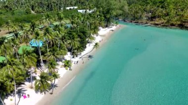 Yumuşak kum ve berrak suların cennet gibi bir kaçış yarattığı Koh Kood Adası 'nın huzurlu güzelliğini keşfedin. Palmiye ağaçları, ziyaretçiler gibi, bu tropik cennette güneşlenmenin ve yüzmenin tadını çıkarırken nazikçe sallanıyor..
